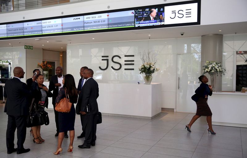 People chat in front of a reception with an electronic