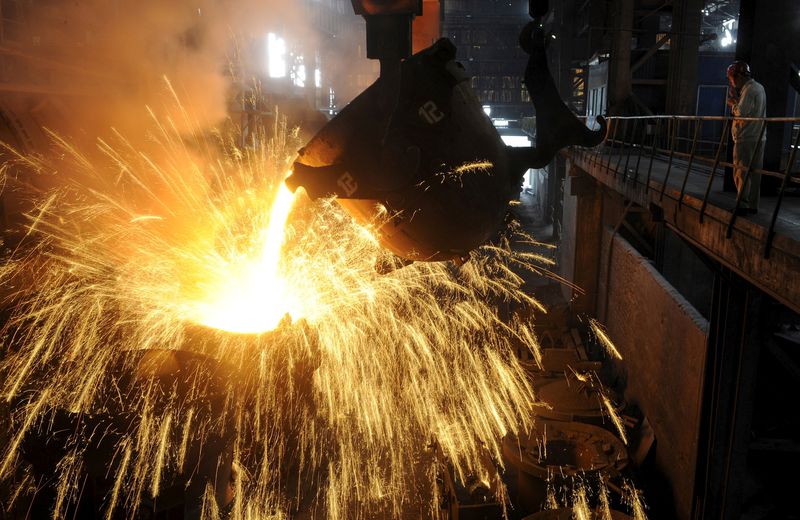 FILE PHOTO: An employee monitors molten iron being poured into