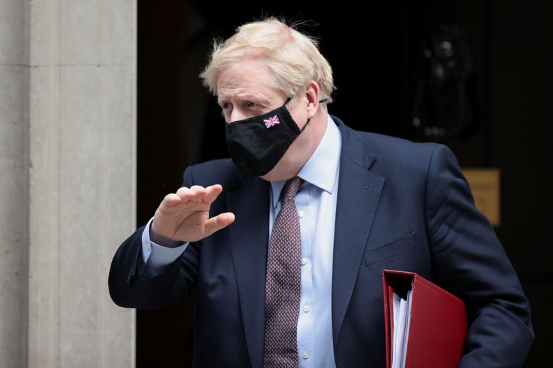 Britain’s PM Johnson walks leaves Downing Street in London