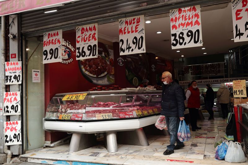 People shop at a meat store in Fatih district in