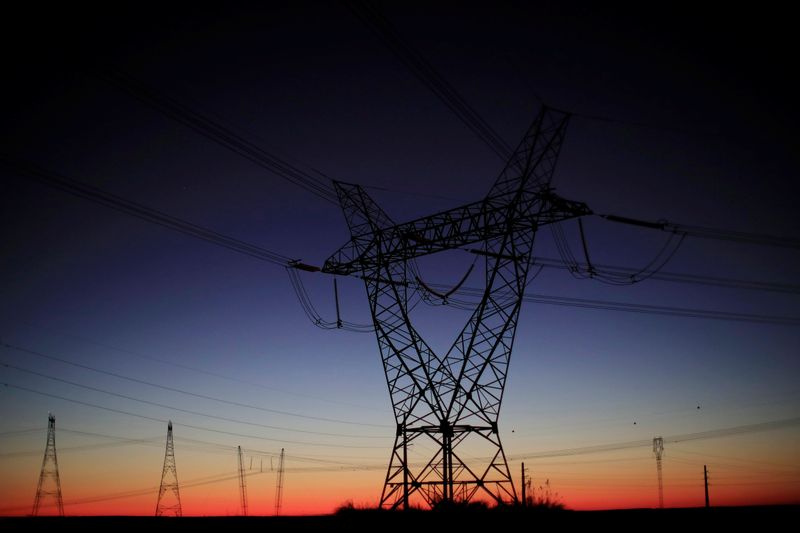 Power lines connecting pylons of high-tension electricity are seen near