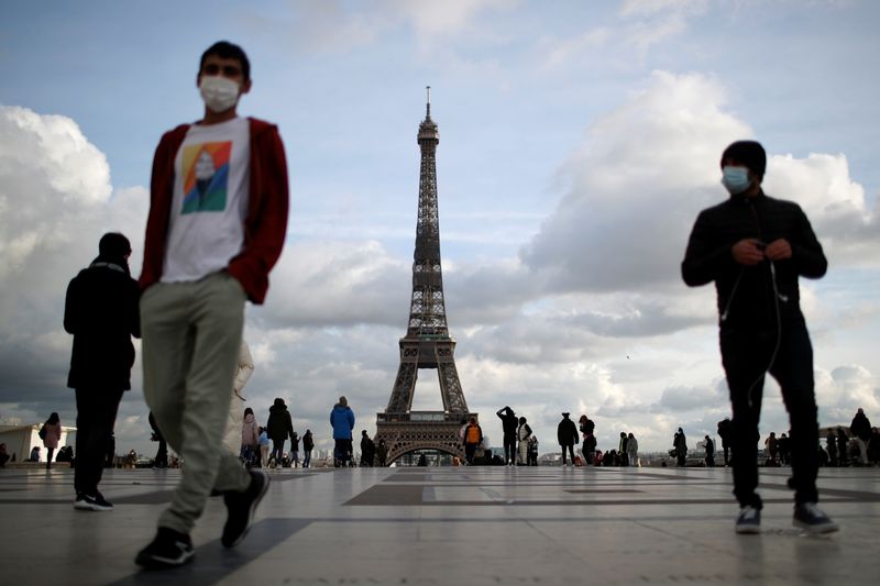People wear protective face masks in Paris