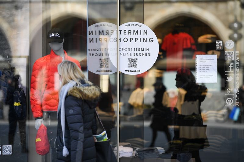 A woman passes a shop with a sticker reading “shopping