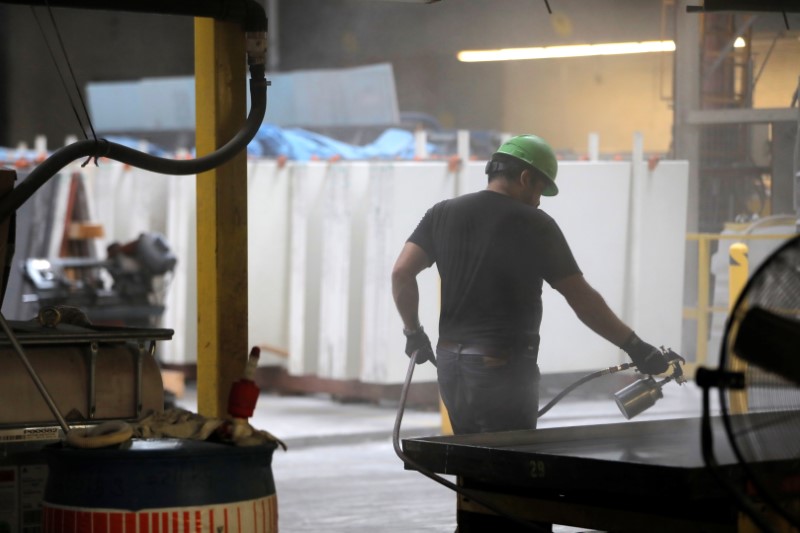 A worker prepares the mold for batching at IceStone, a
