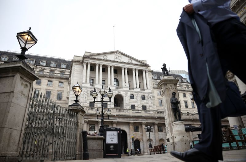 A person walks past the Bank of England in the
