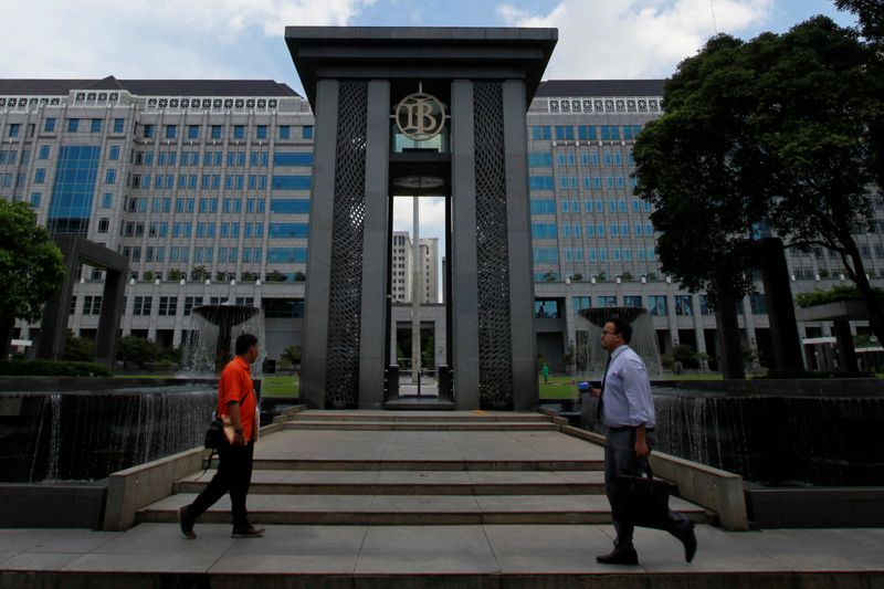 People walks near the fountain of Indonesia’s central bank, Bank