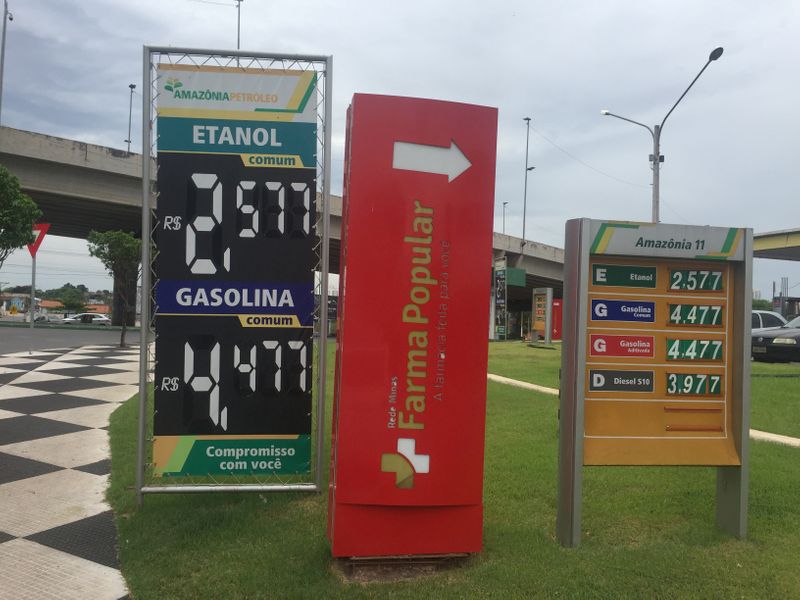 FILE PHOTO: A placard shows prices for ethanol and gasoline