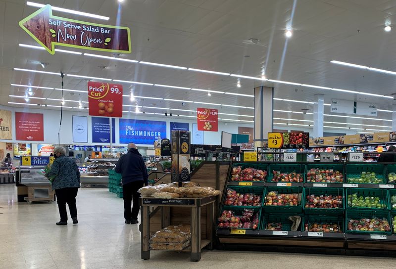 Customers wearing face masks are seen inside a Morrisons supermarket