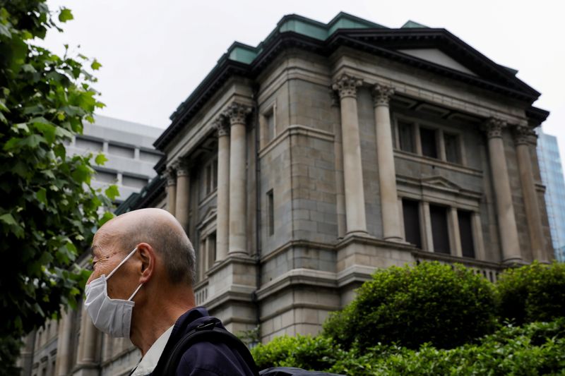 FILE PHOTO: A man wearing a protective mask stands in