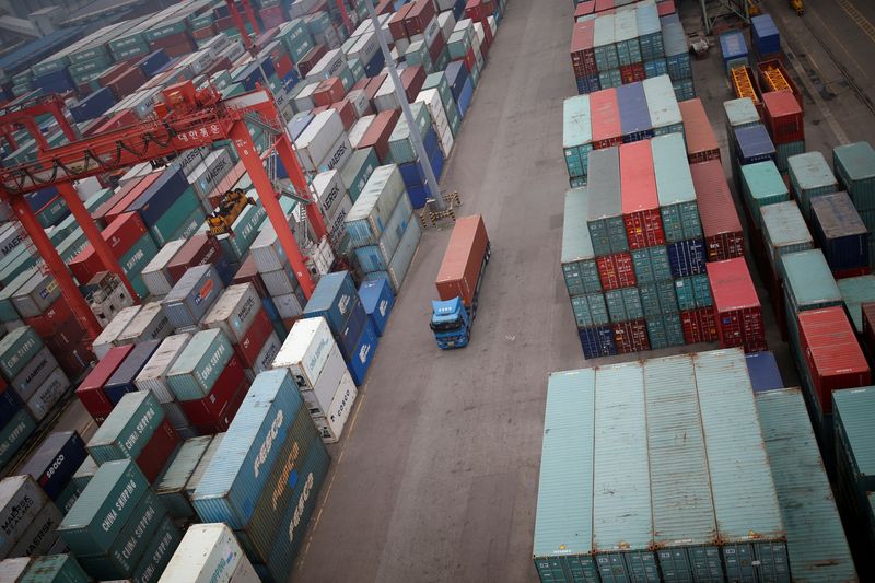 FILE PHOTO: A truck drives between shipping containers at a