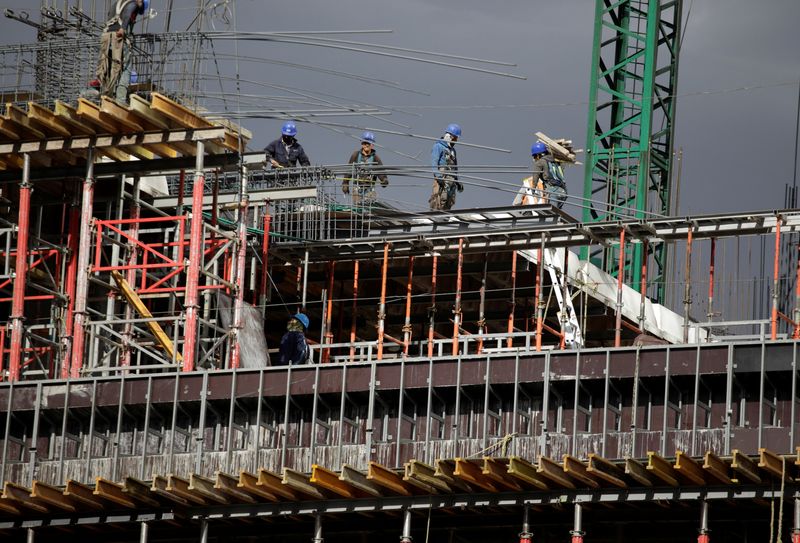 Workers are seen in a building undergoing construction at Mexico