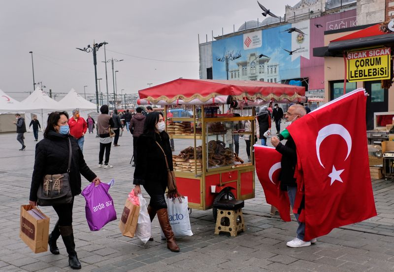 Shoppers carry bags as they stroll at the Eminonu district