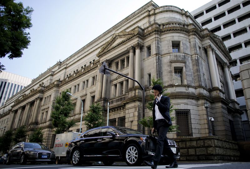 Man walks past the BOJ building in Tokyo