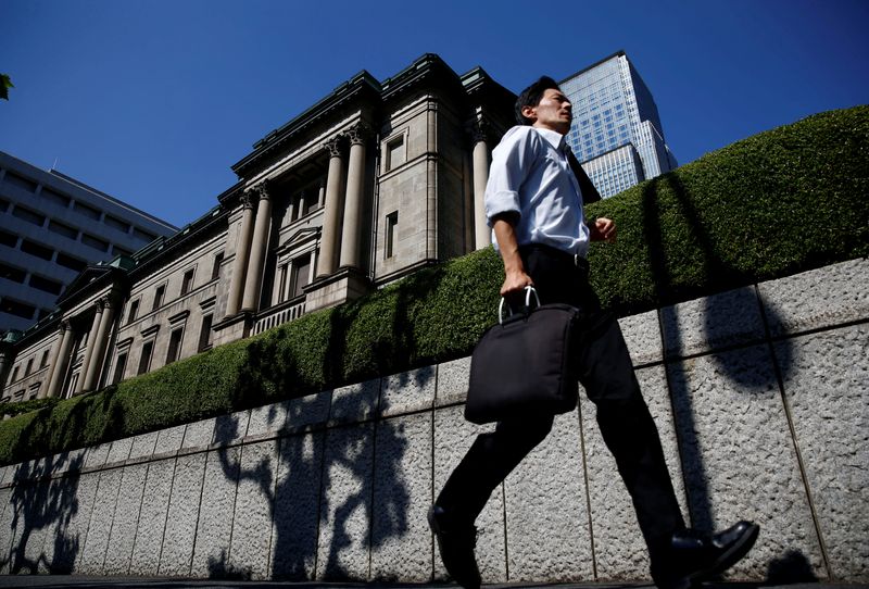 A man runs past the Bank of Japan (BOJ) building