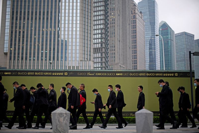 Security guards walk along at financial district of Lujiazui in