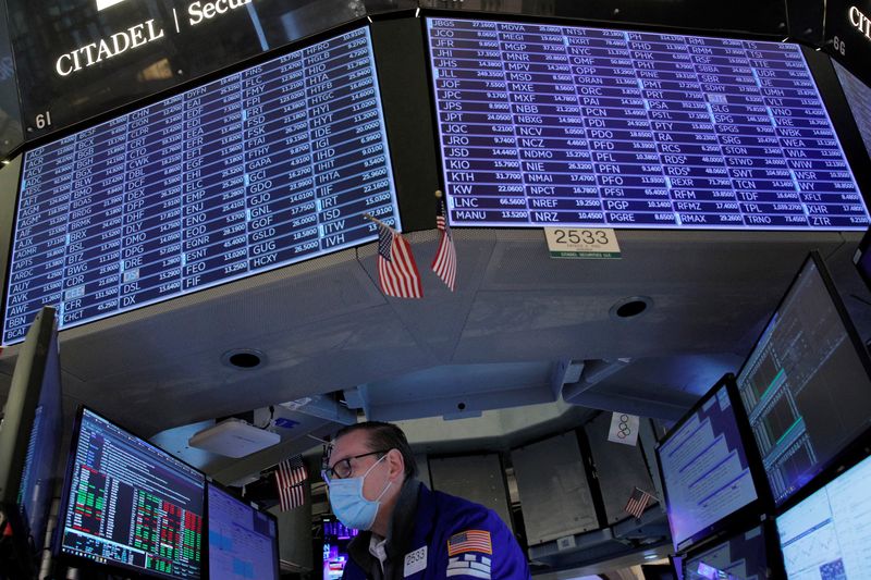 FILE PHOTO: Traders work on the floor of the NYSE