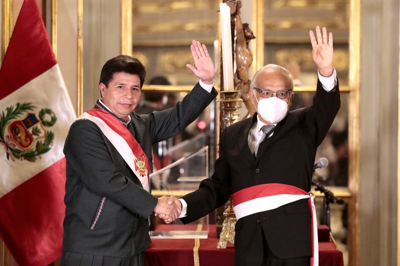 Peru’s President Pedro Castillo and Anibal Torres wave after Torres