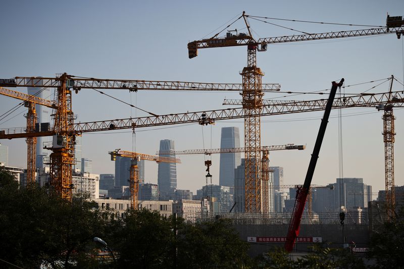 A view shows cranes in front of the skyline of