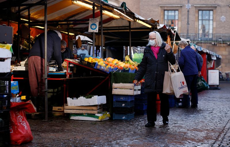 A woman wearing a face mask shops in Cambridge Market