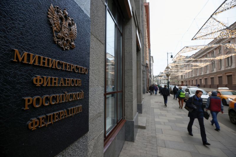 FILE PHOTO: Pedestrians walk past Russia’s Finance Ministry building in