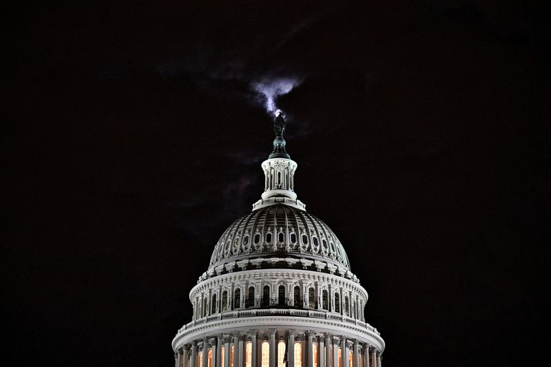 The moon is seen behind the dome of the U.S.
