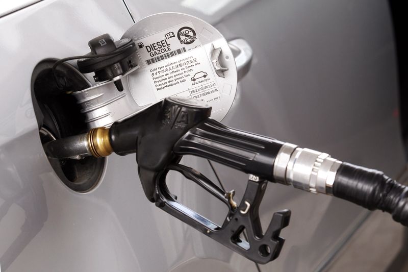 A view shows a petrol nozzle refuelling a car at