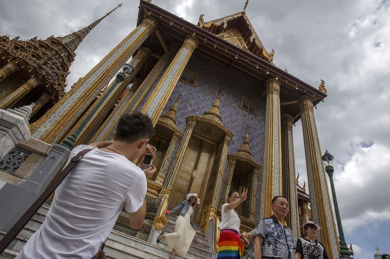 Tourists visit the Grand Palace in Bangkok