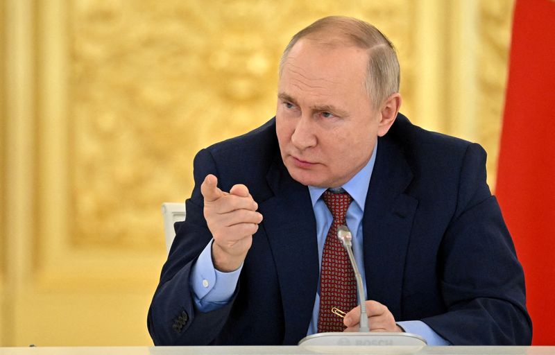 FILE PHOTO: Russian President Putin meets with members of the