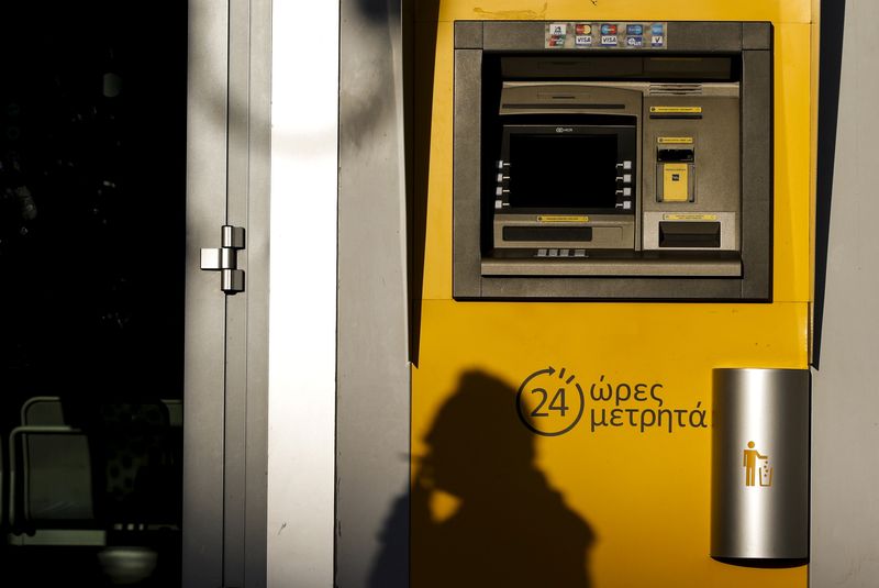 FILE PHOTO: A man cast his shadow on an ATM