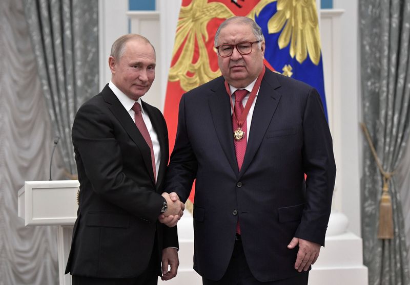 Russian President Putin and Russian businessman Usmanov attend an awarding