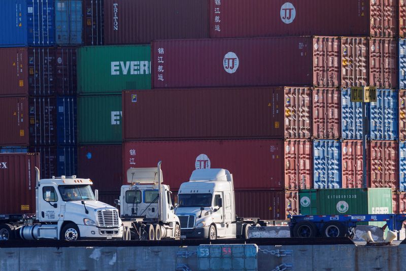 FILE PHOTO: Trucks arrive to pick up containers at the