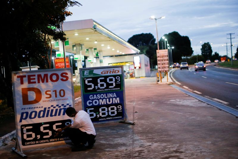 A worker updates fuel prices at a Brazilian oil company