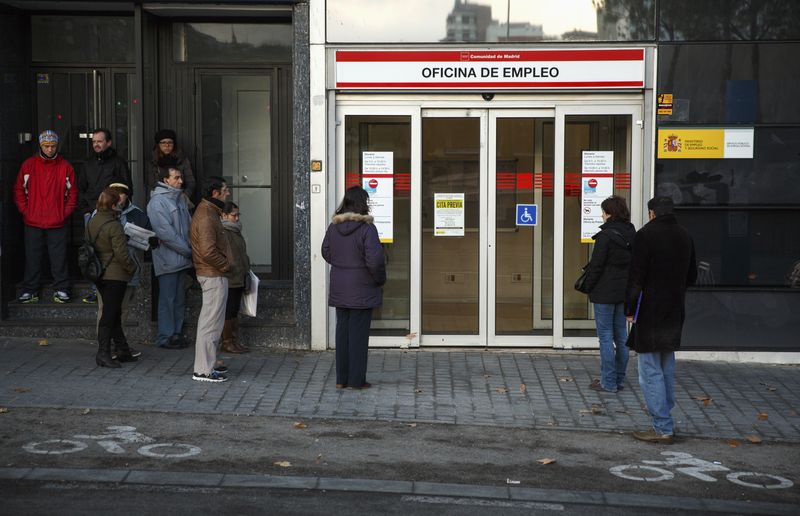 People wait in front of a government-run employment office in