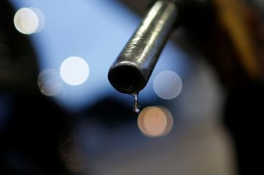 Gasoline drips from the nozzle of a fuel pump at