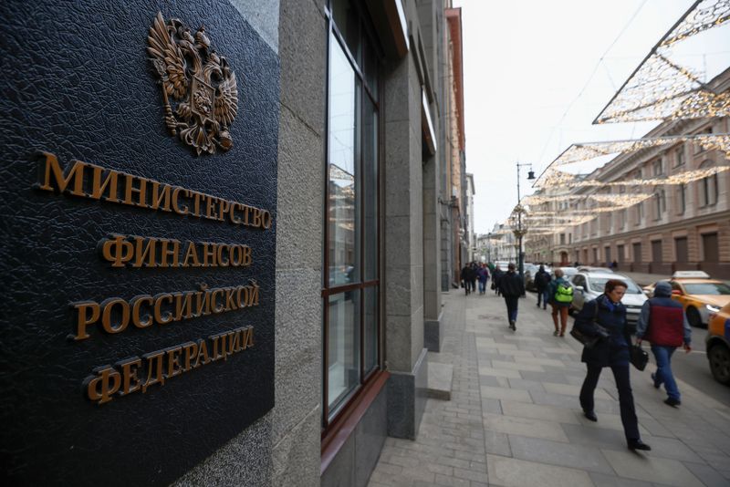 Pedestrians walk past Russia’s Finance Ministry building in Moscow