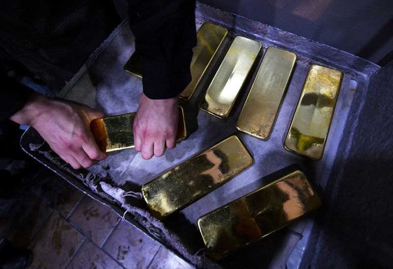 An employee processes ingots of 99.99 percent pure gold at