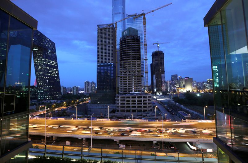 Vehicles drive through Beijing’s central business area