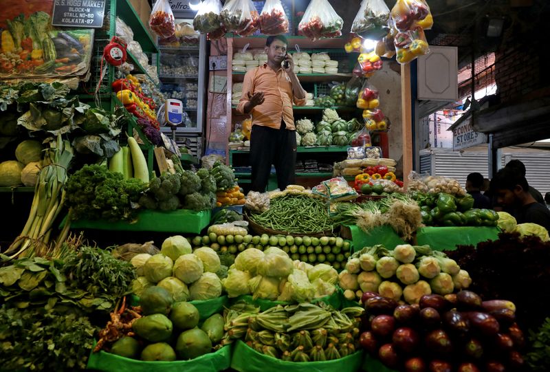 FILE PHOTO: Debashis Dhara, a vegetable vendor, speaks on his
