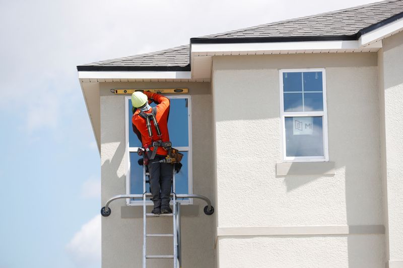 FILE PHOTO: A carpenter works on new townhomes in Tampa