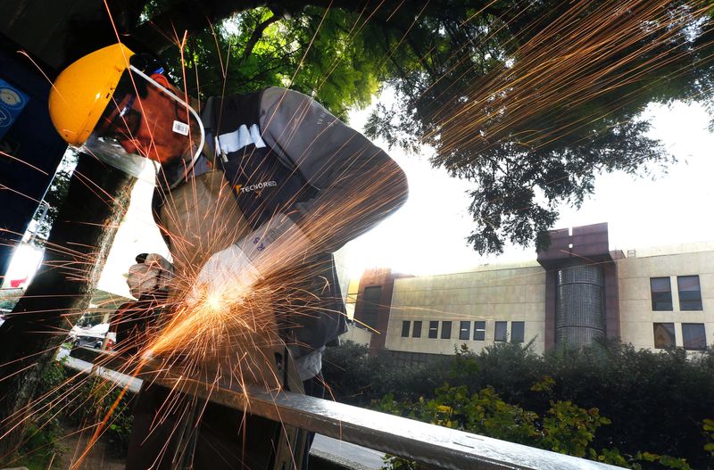 FILE PHOTO: A worker cuts a metal structure for arrangements