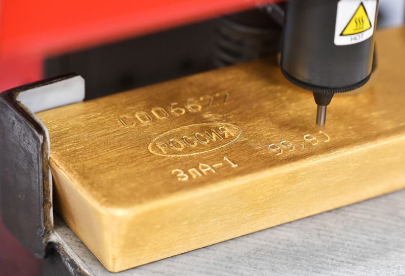A machine engraves information on an ingot of 99.99 percent