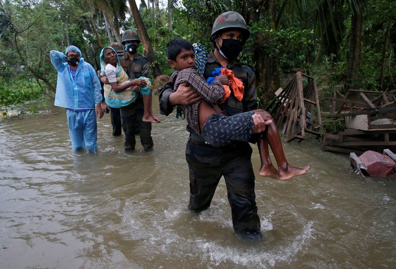 FILE PHOTO: Army soldiers evacuate people from a flooded area