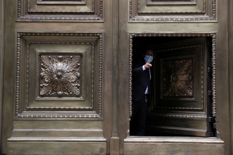 FILE PHOTO: A security worker gestures while closing the door