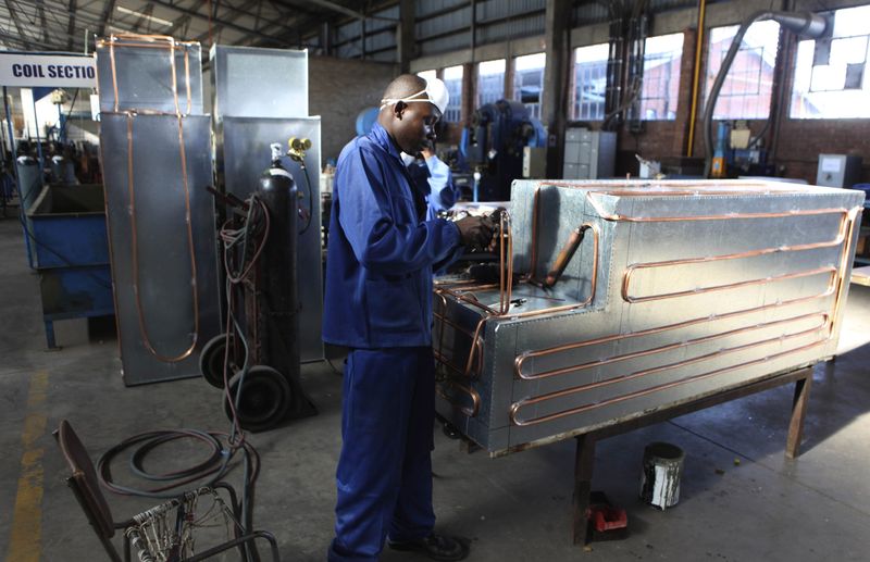 FILE PHOTO: An employee works at a fridge manufacturing company