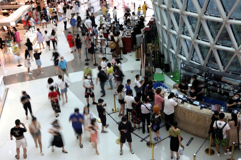 FILE PHOTO: People shop at the Sanya International Duty-Free Shopping