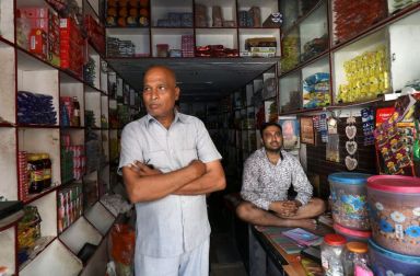 Shopkeeper looks on as he waits for customers at Kasan