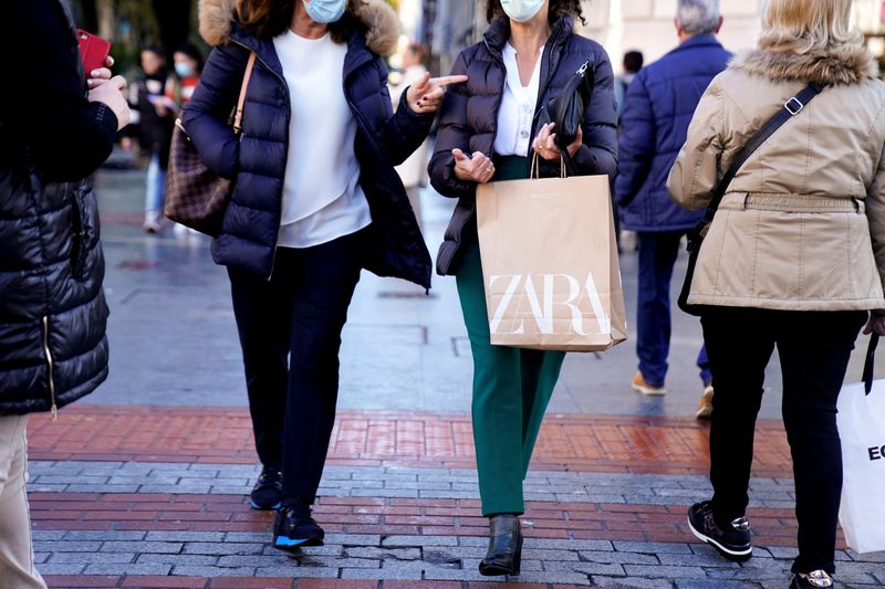 FILE PHOTO: A shopper carries bags from Zara clothes store