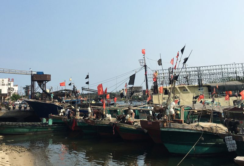 Fishing boats with Chinese national flags are seen at a