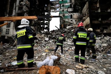 FILE PHOTO: Rescuers search for bodies under the rubble of