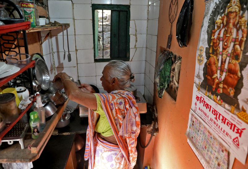 Gita Sen prepares her morning tea inside her rented one-room